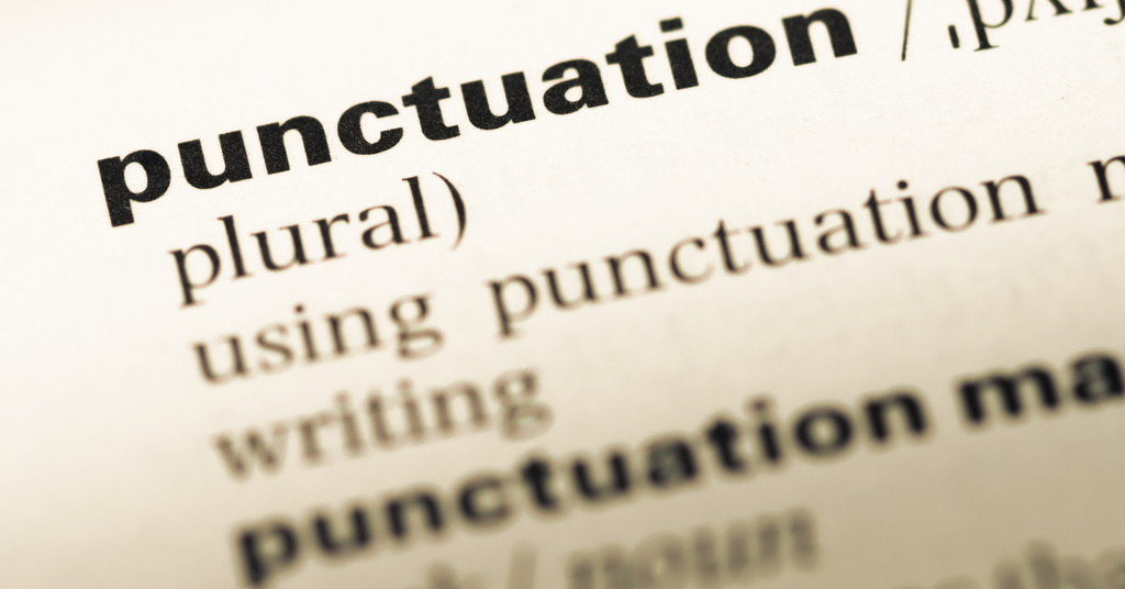 close up of english dictionary page with word punctuation
