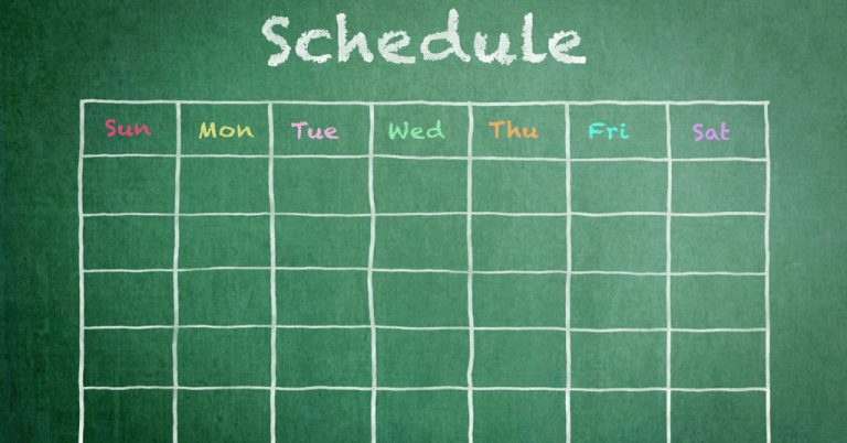 Schedule with grid time table on green chalkboard