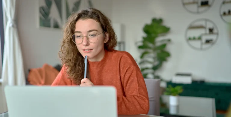 Student reading ACT study guide and then starting an ACT practice test with UWorld College Prep