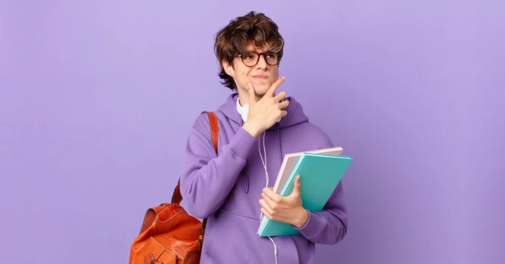 High school student holding books wearing purple wondering about common mistakes on ACT Math and how to avoid them.