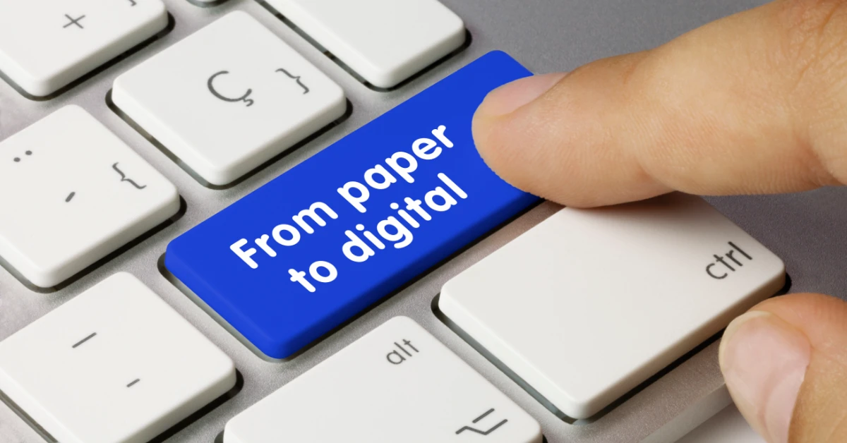 Person clicking a computer keyboard button that says “From paper to digital”