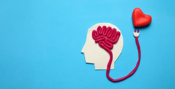 Abstract image of a person’s head with the brain powered by the heart, symbolizing the connection between emotion and cognition—perfect for students exploring key AP Psychology themes over the summer.